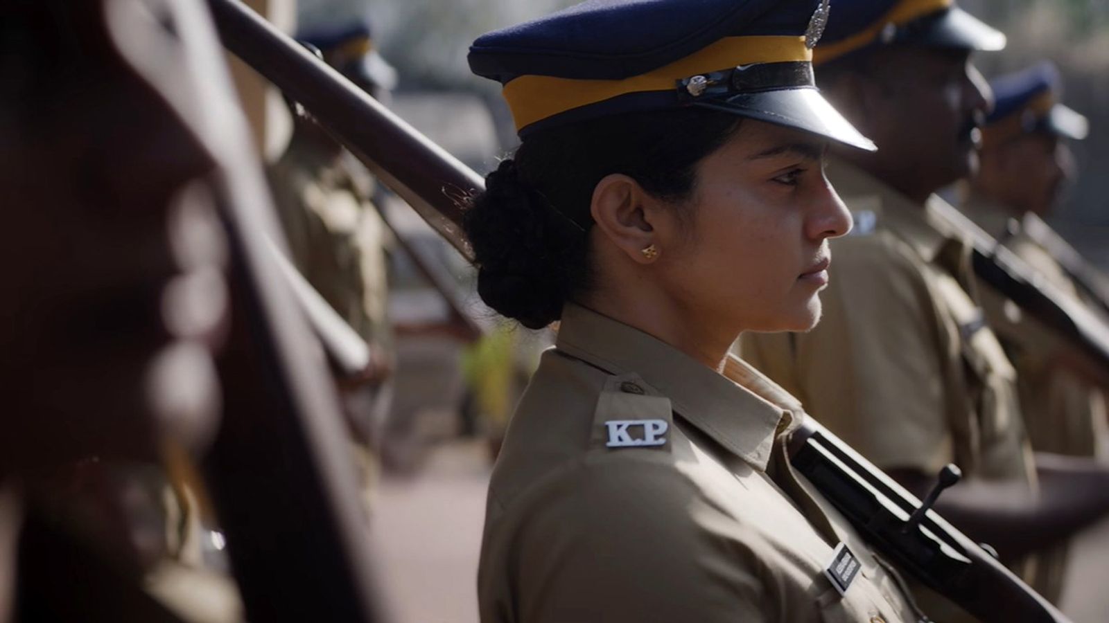 Parvathy Thiruvothu in Kerala Police uniform and cap in a Pradhama Drishtya Kuttakkar still