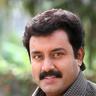 Suresh Krishna with a moustache in a checked shirt, portrait