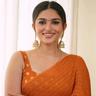 Kayadu Lohar in an orange saree, smiling, half-length portrait