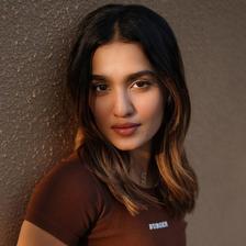 Saniya Iyappan in a brown crop top, half-length portrait
