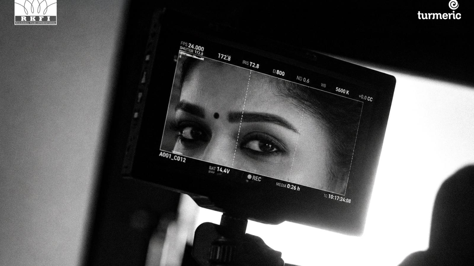 A camera monitor showing a woman's eyes in black and white, from RKFI's Dharman announcement poster