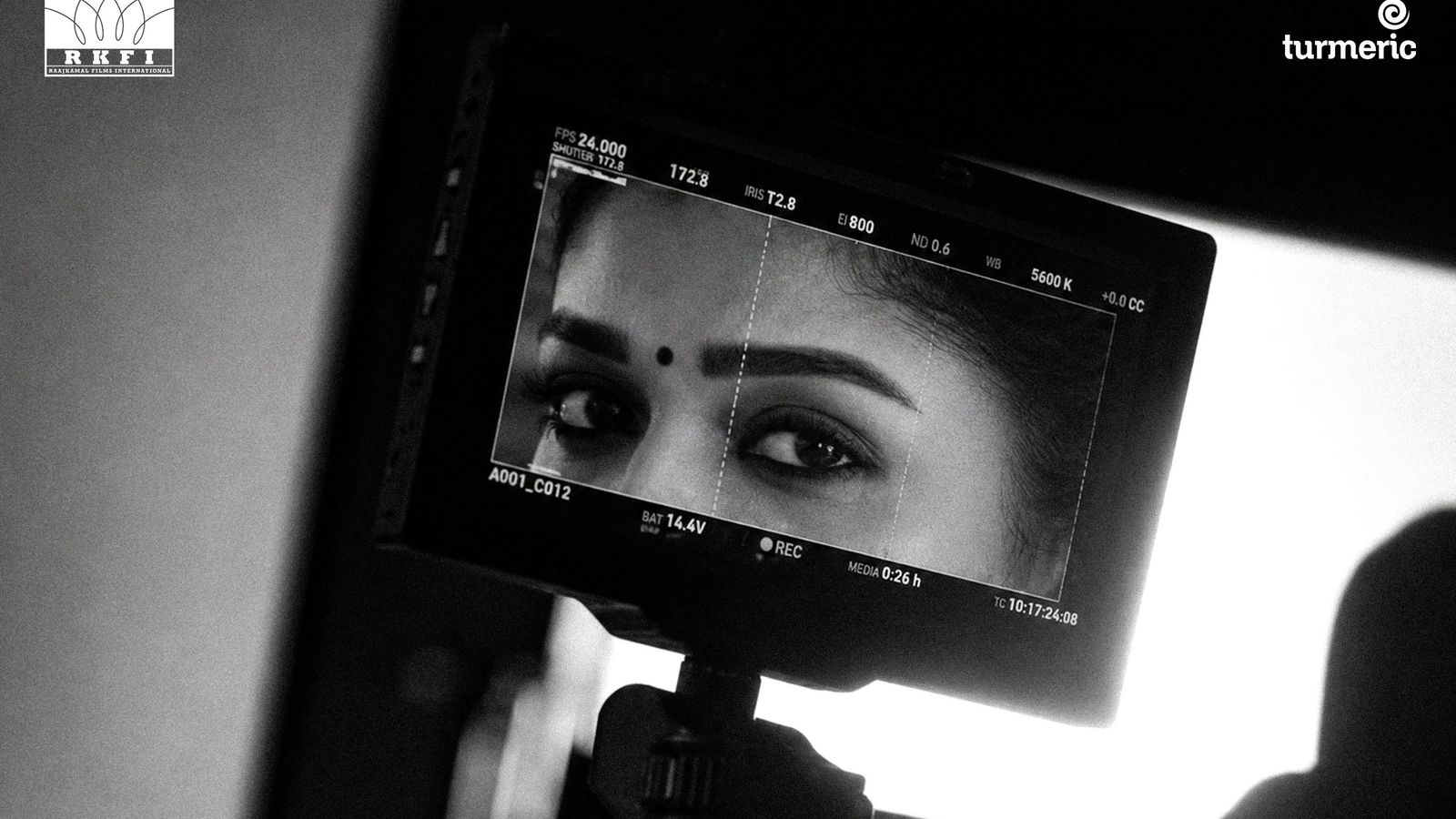 A camera monitor showing a woman's eyes in black and white, from RKFI's Dharman announcement poster