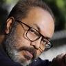 Shammi Thilakan in glasses with a grey beard, close-up portrait