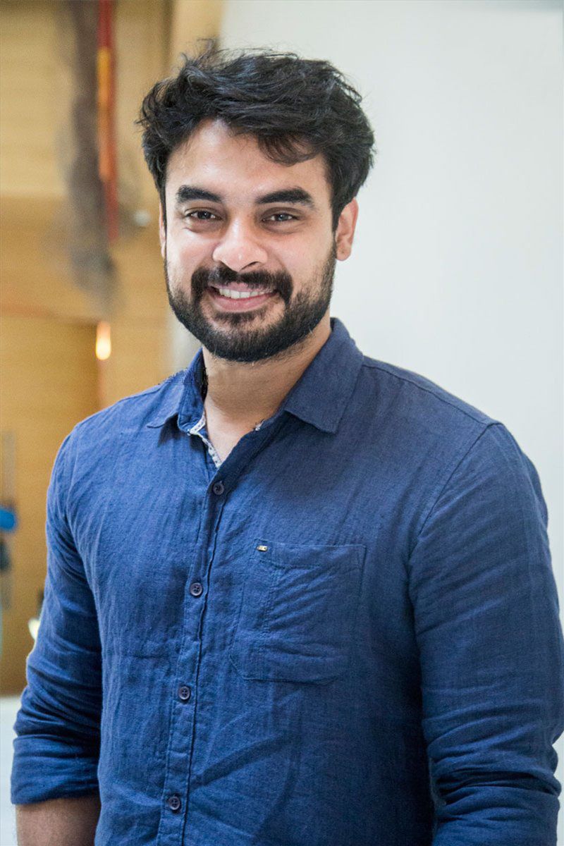 Tovino Thomas with a beard in a blue shirt, portrait