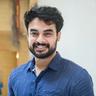 Tovino Thomas with a beard in a blue shirt, portrait