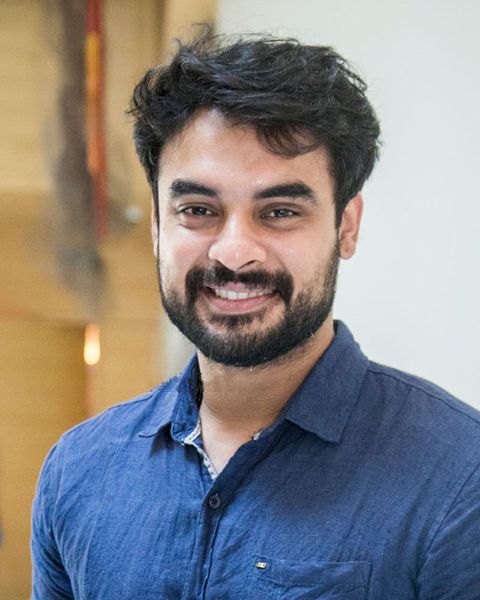 Tovino Thomas with a beard in a blue shirt, portrait