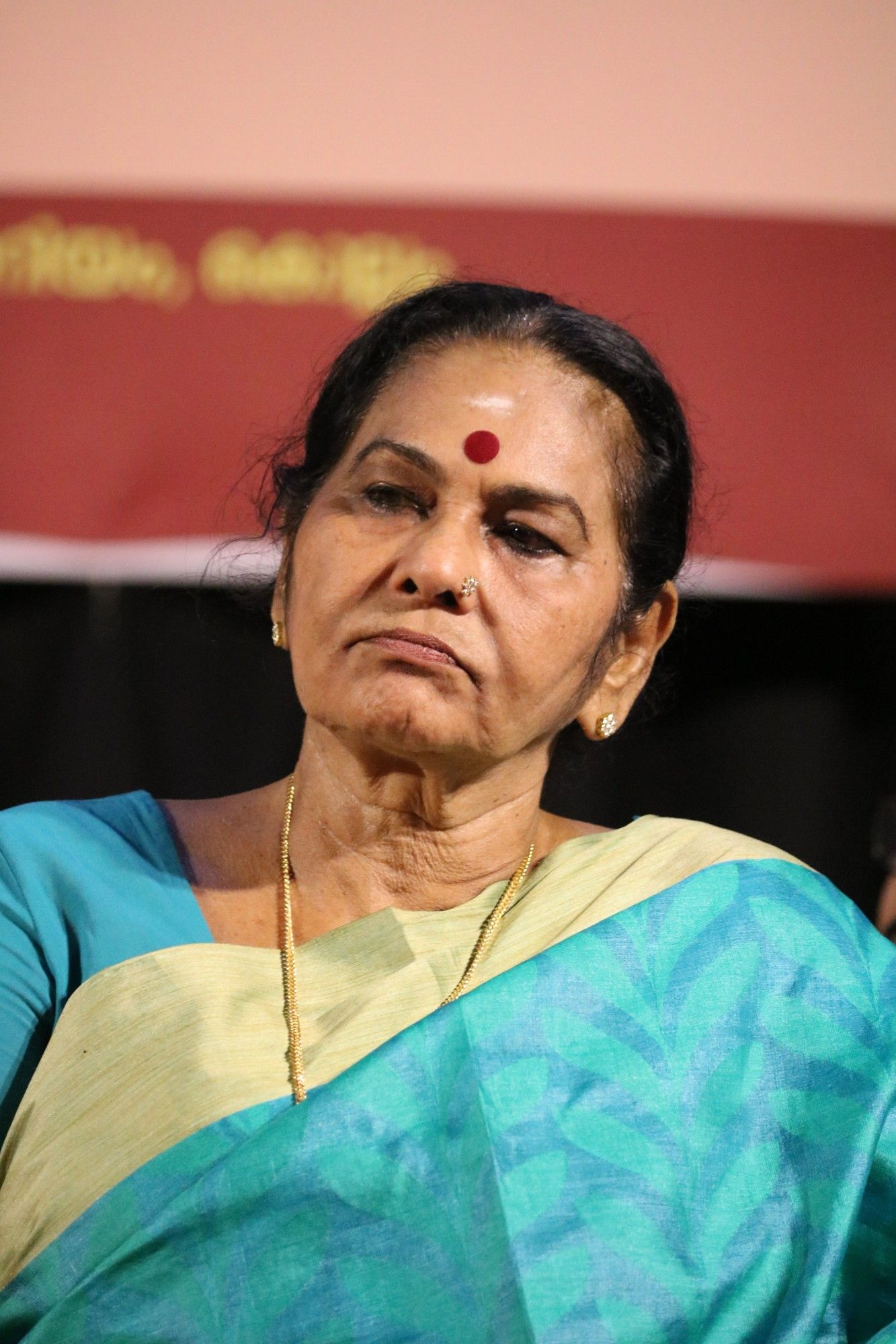 KPAC Lalitha in a blue saree with a red bindi at an event