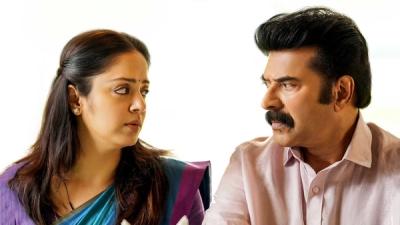 Kaathal – The Core still of Jyotika and Mammootty facing each other at home