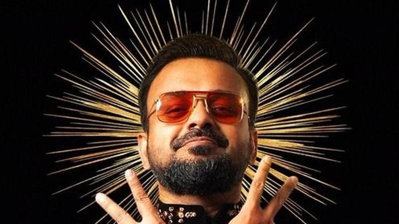 Kunchacko Boban as Dheeraj Prabhu, in sunglasses and a gold halo, on the Bachelor Party D'eux character poster