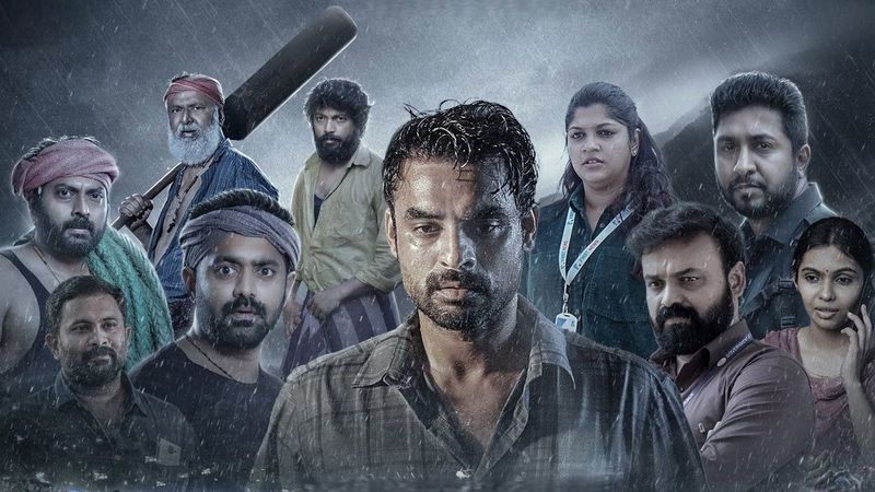 Tovino Thomas with the cast in a still from the flood survival drama 2018