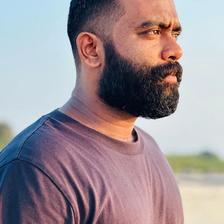 Sajin Gopu with a beard in a T-shirt, outdoor side profile
