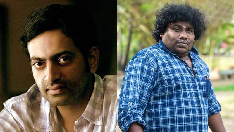Saiju Kurup in a checked shirt, and Yogi Babu in a blue checked shirt, side by side.