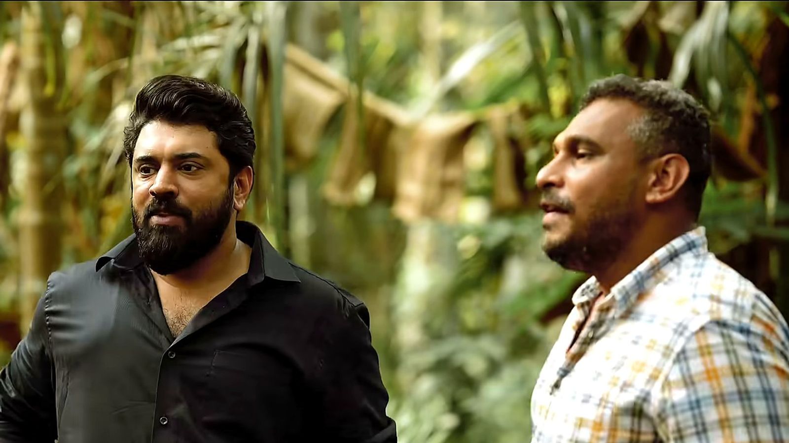 Nivin Pauly in a black shirt on a forest location in the Bethlehem Kudumba Unit making video.