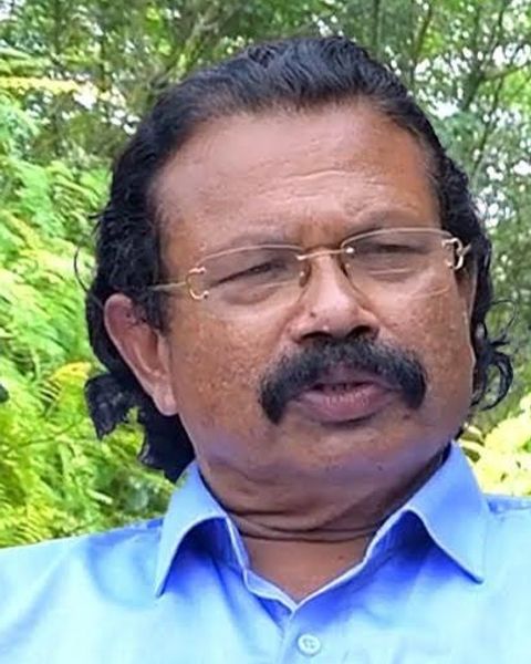 Tomichan Mulakuppadam in glasses with a moustache outdoors