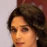 Nyla Usha with long hair and a pendant necklace, portrait
