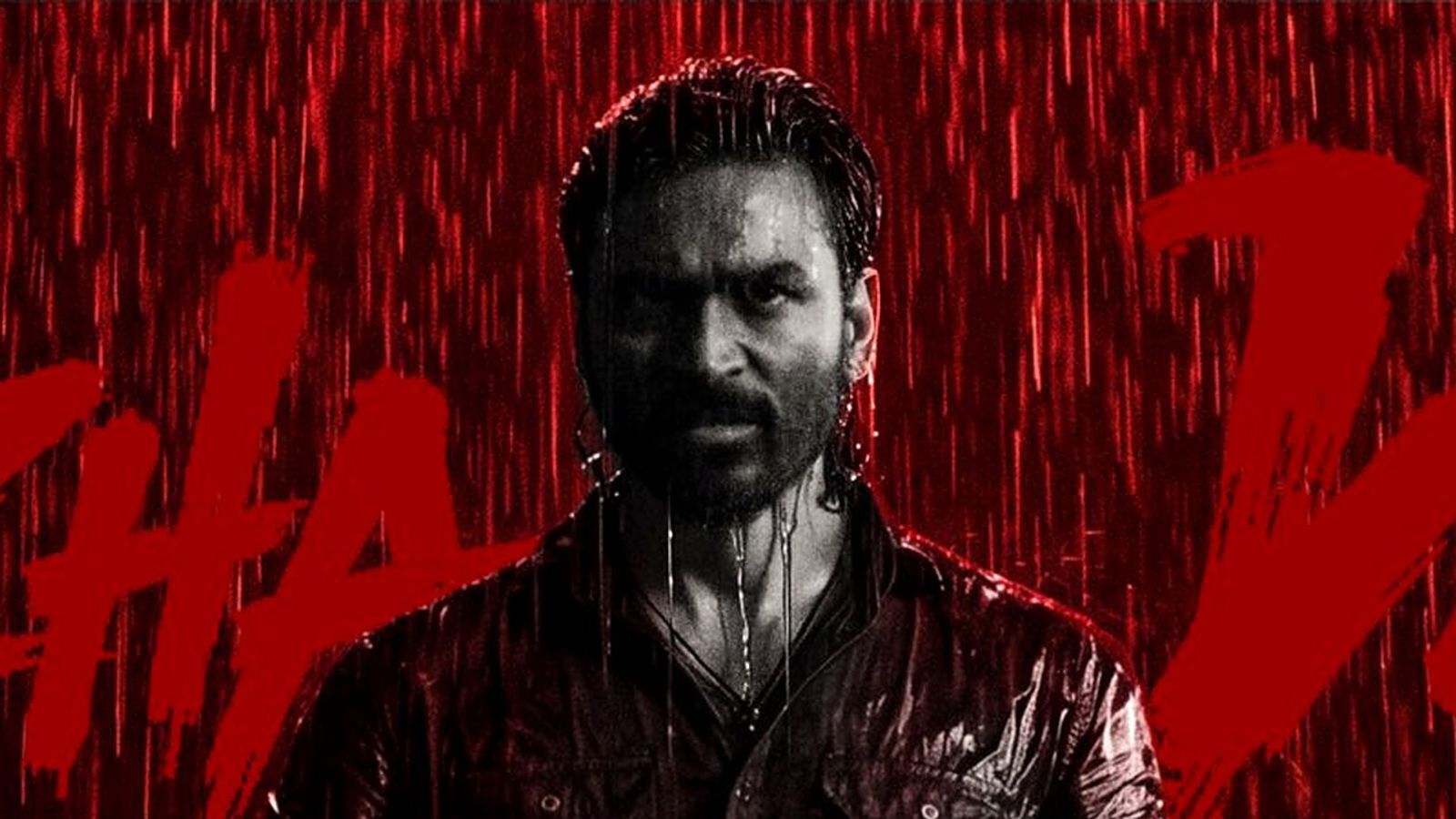 Dhanush, drenched in red-lit rain, in the Veezha Veera song poster from OM.