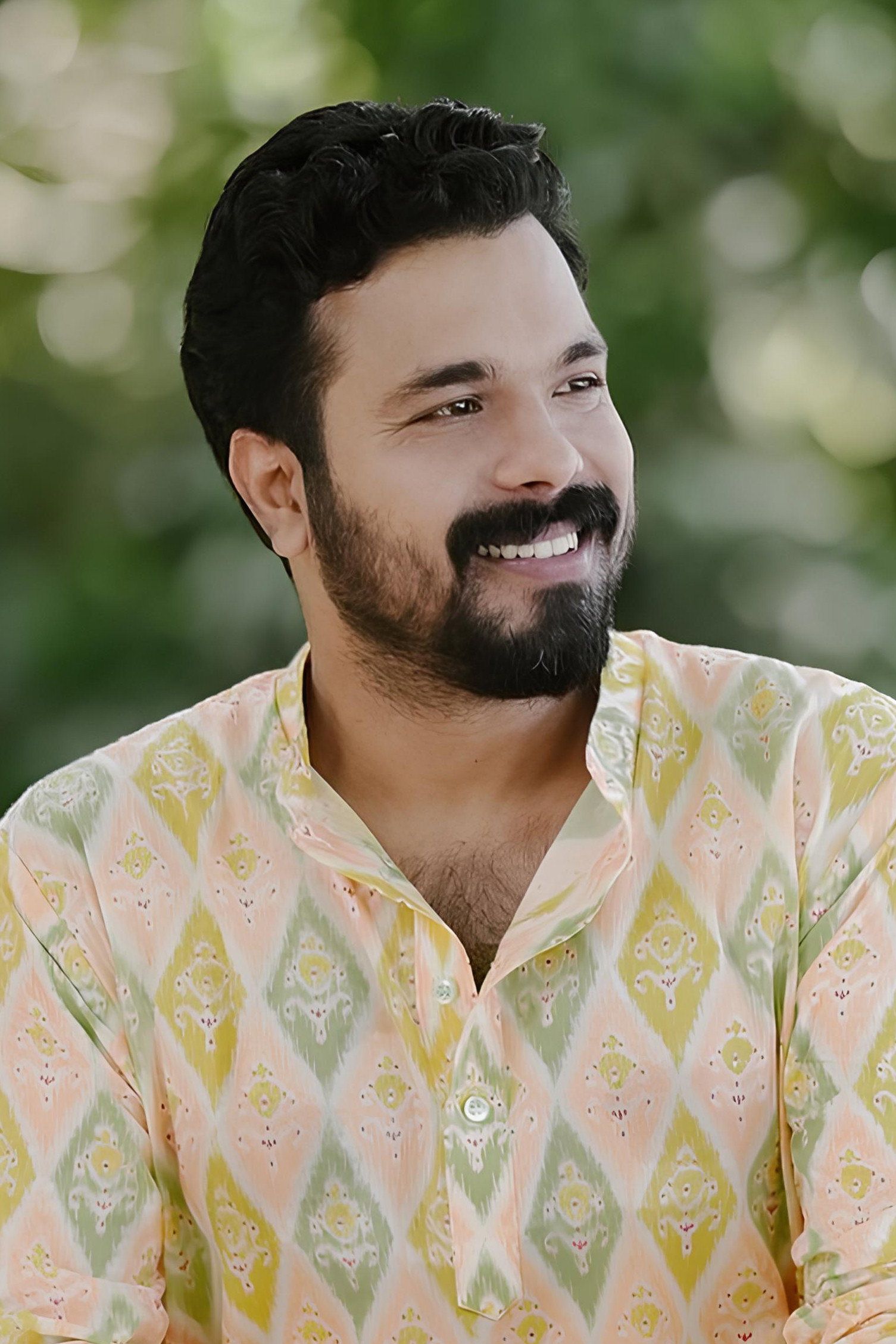 Abhiram Radhakrishnan smiling in a pastel ikat-print kurta, head-and-shoulders portrait