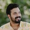 Abhiram Radhakrishnan smiling in a pastel ikat-print kurta, head-and-shoulders portrait