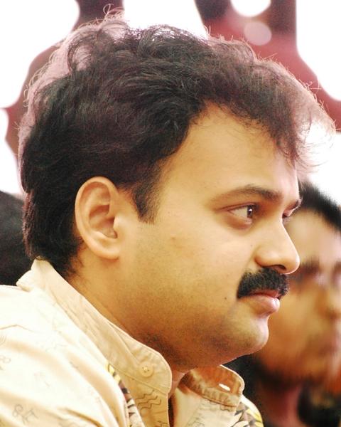 Kunchacko Boban with a moustache looking to the side, close-up portrait