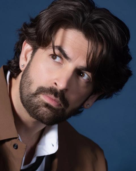 Neil Nitin Mukesh with tousled hair and a beard, portrait