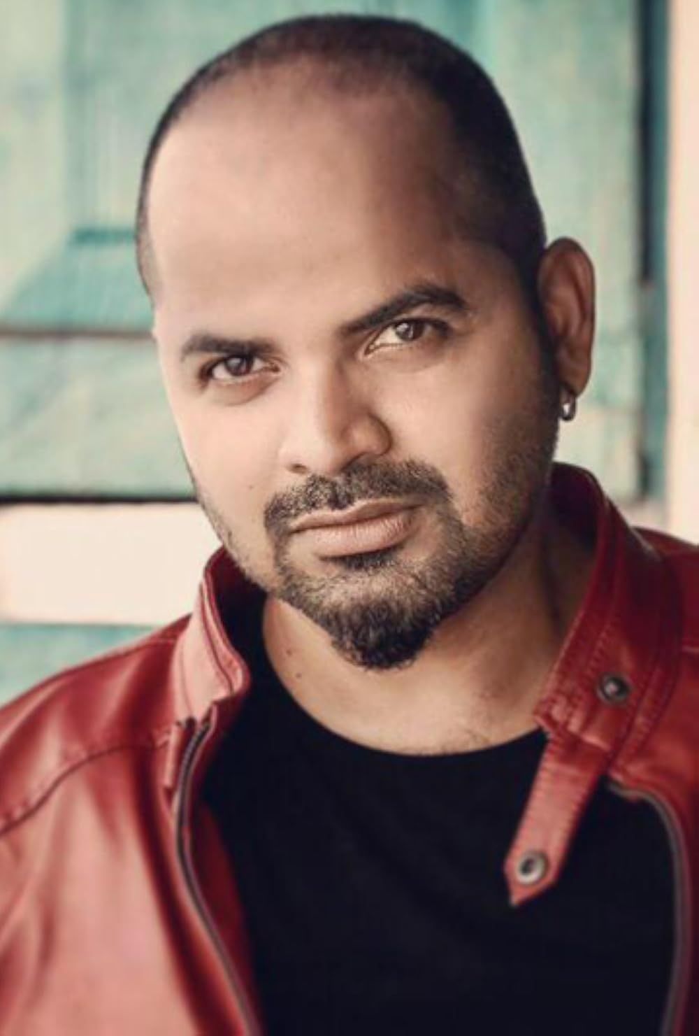 Vinay Forrt in a red jacket over a black T-shirt, half-length portrait