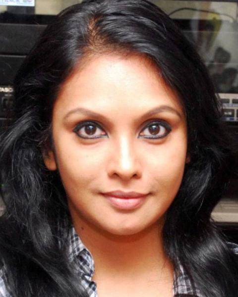 Jyothirmayi with long dark hair looking at the camera, close-up portrait