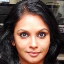 Jyothirmayi with long dark hair looking at the camera, close-up portrait