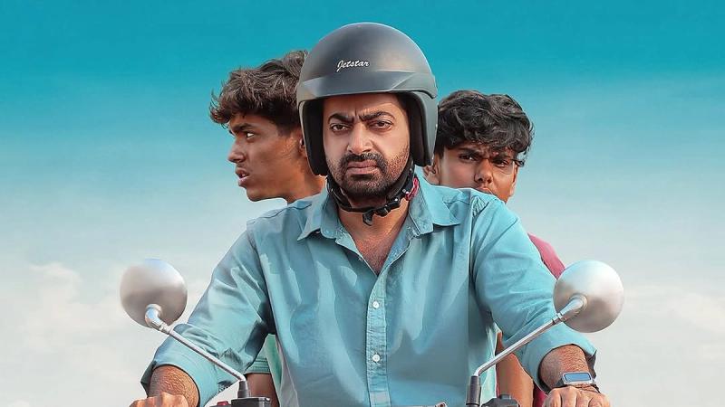 Saiju Kurup in a helmet riding a motorbike with two teenage boys behind him in the Bafana United first look