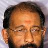 Nedumudi Venu with glasses and a grey beard, close-up portrait