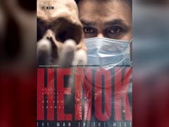 Dileep in a surgical mask with a skull in the foreground on the Henok The Man in the Mist first look poster