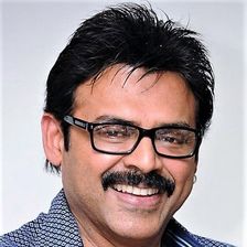 Venkatesh smiling in glasses and a checked shirt, portrait