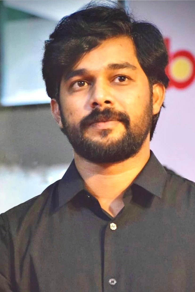 Sharafudheen with a beard in a black shirt, portrait