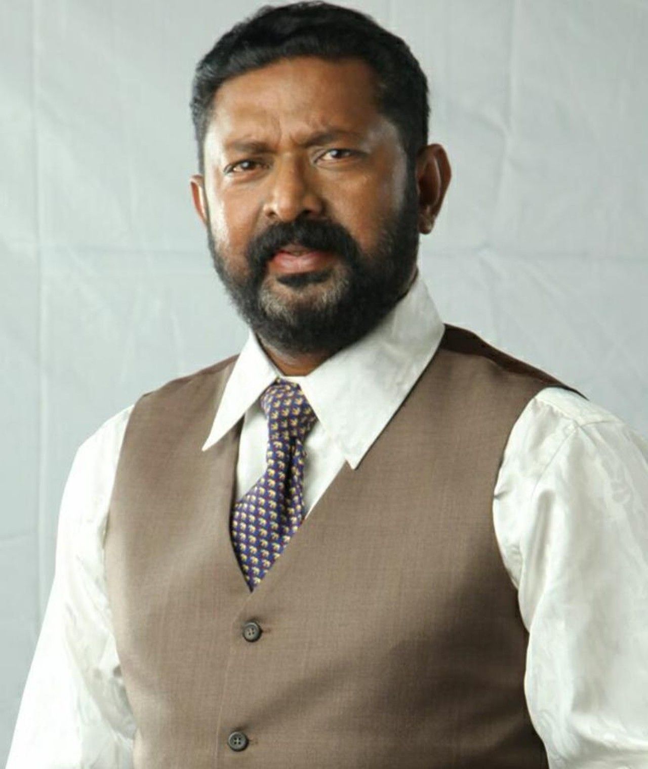 Lal with a beard in a waistcoat and tie, portrait