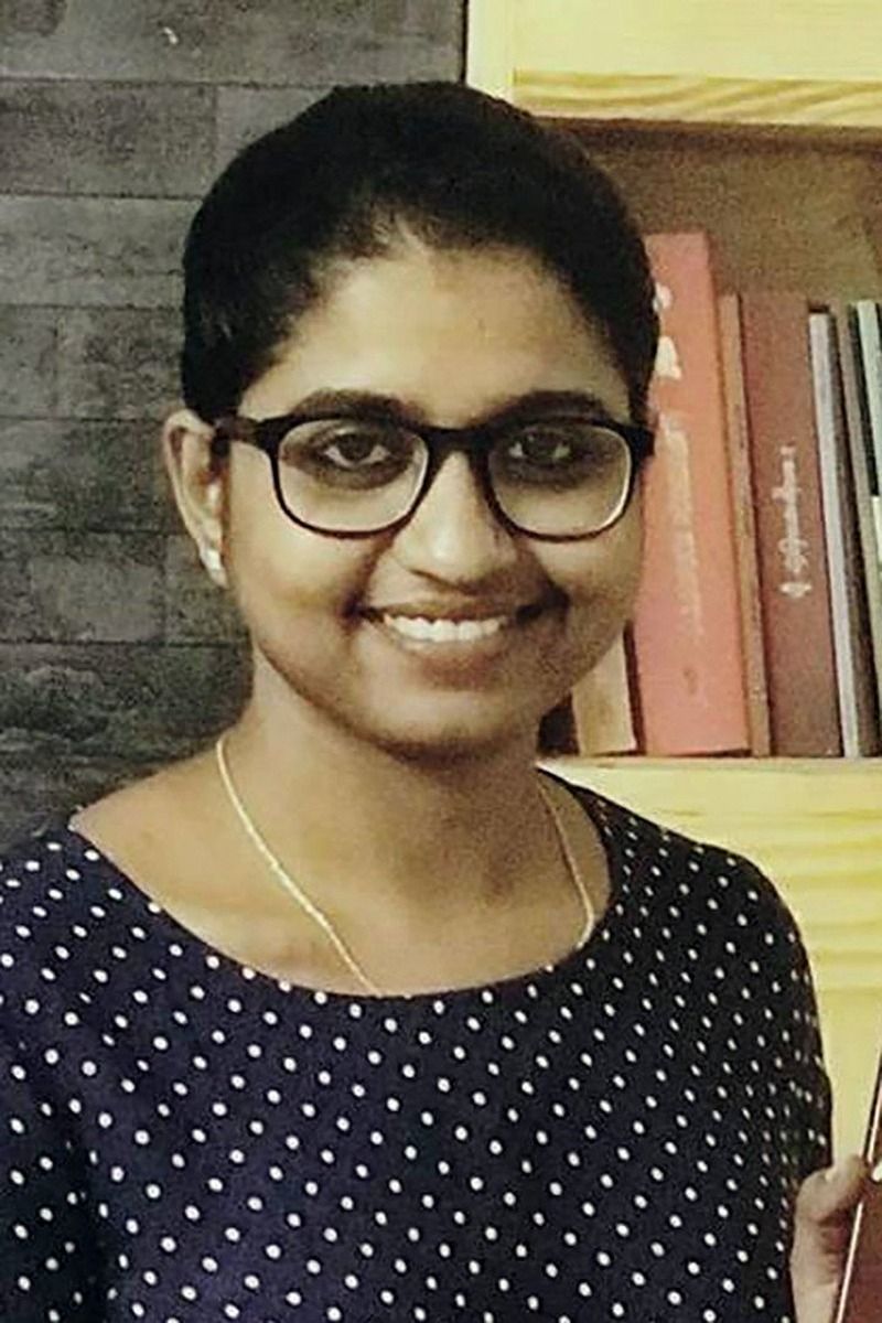 Unnimaya Prasad smiling in glasses and a polka-dot top