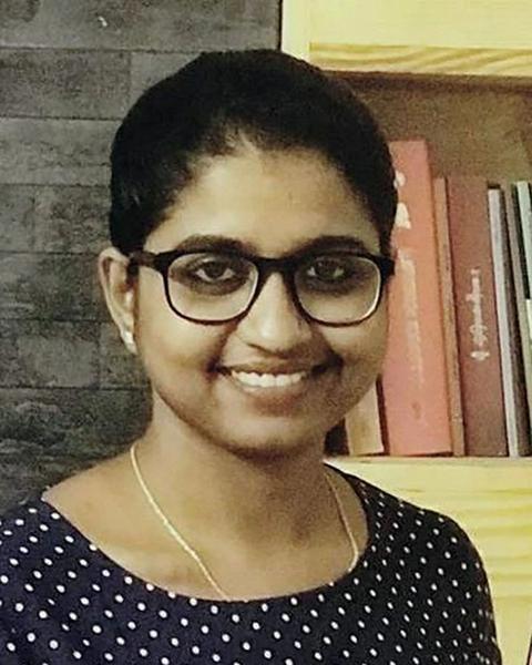 Unnimaya Prasad smiling in glasses and a polka-dot top