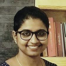 Unnimaya Prasad smiling in glasses and a polka-dot top