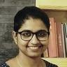 Unnimaya Prasad smiling in glasses and a polka-dot top