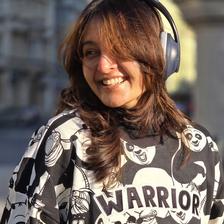 Manju Warrier smiling in headphones and a printed panda sweatshirt
