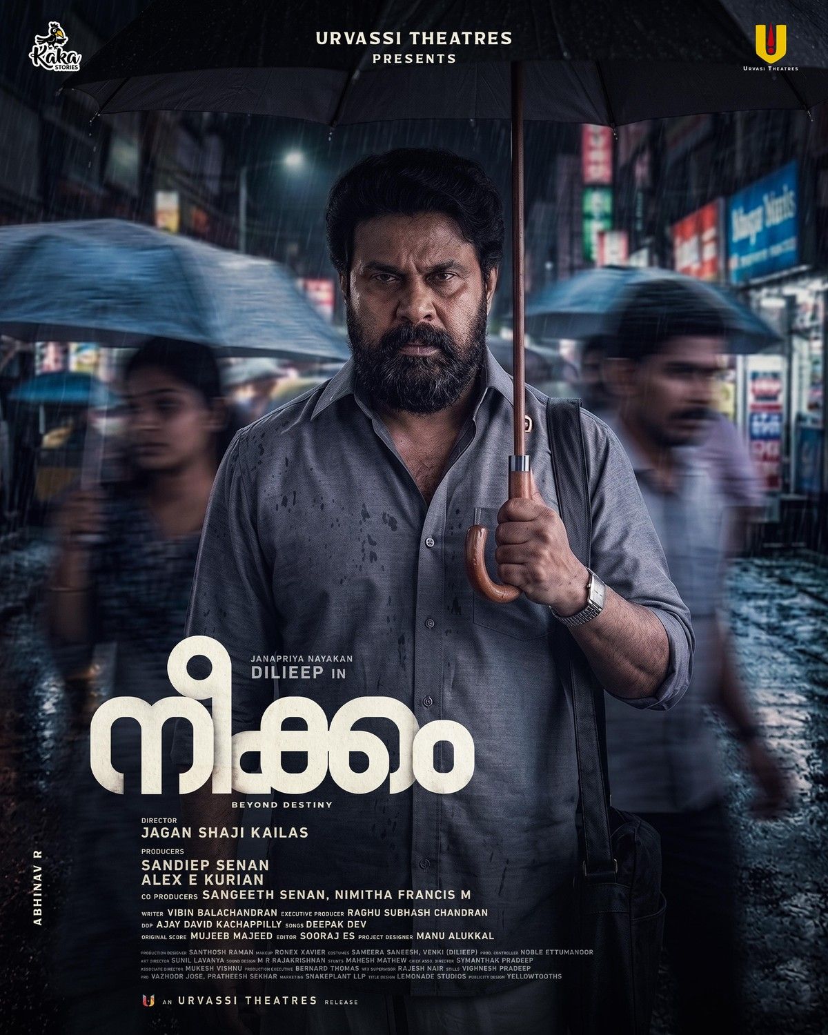 Neekkam poster with Dileep holding an umbrella on a rainy night street