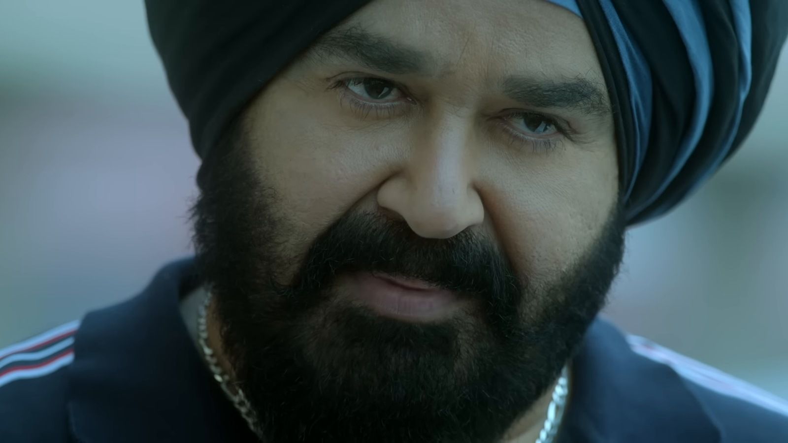 Mohanlal in a dark turban and beard, in a close-up from the Monster trailer
