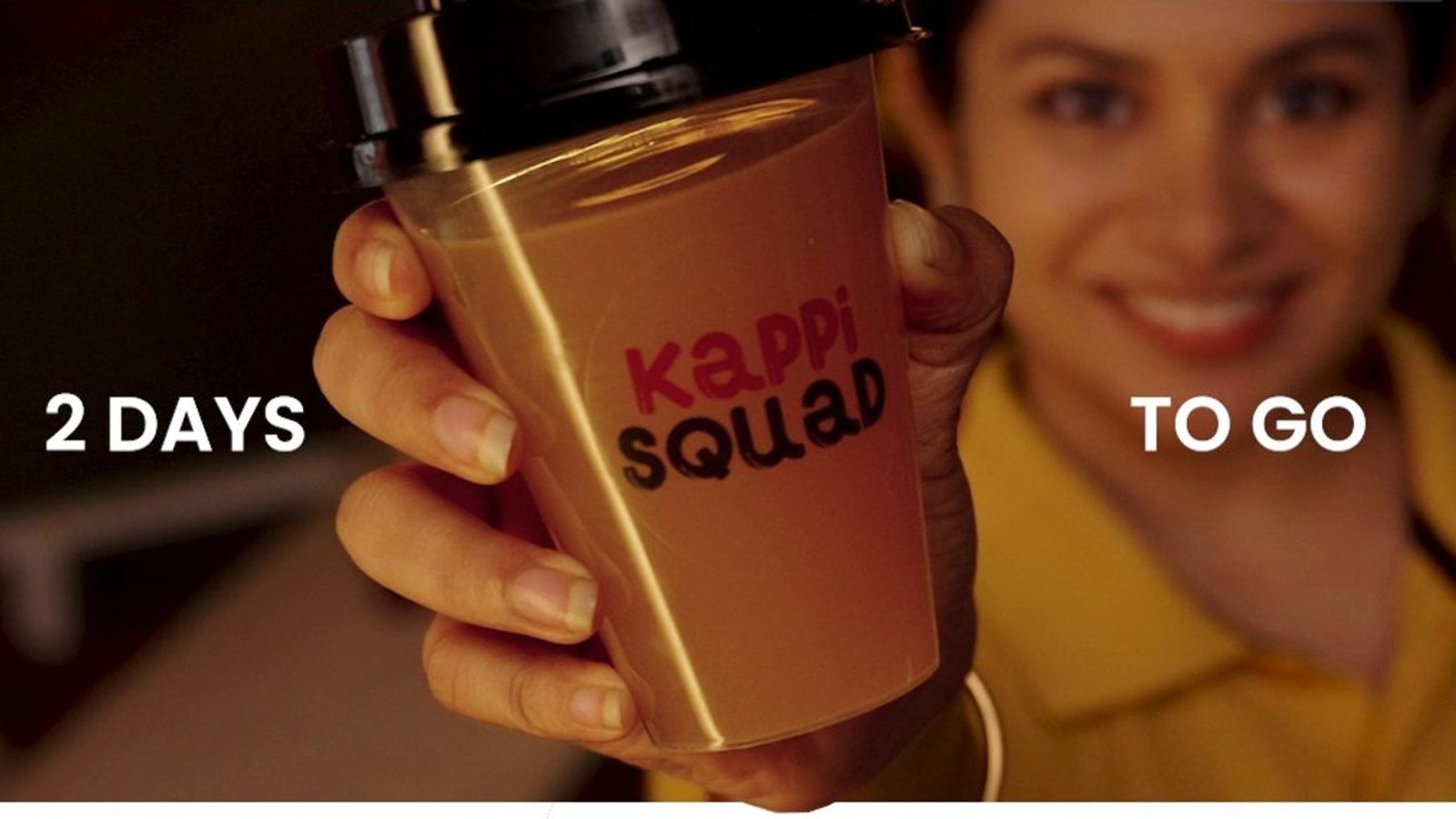 A hand holds up a Kappi Squad cup in official JioHotstar artwork for the series