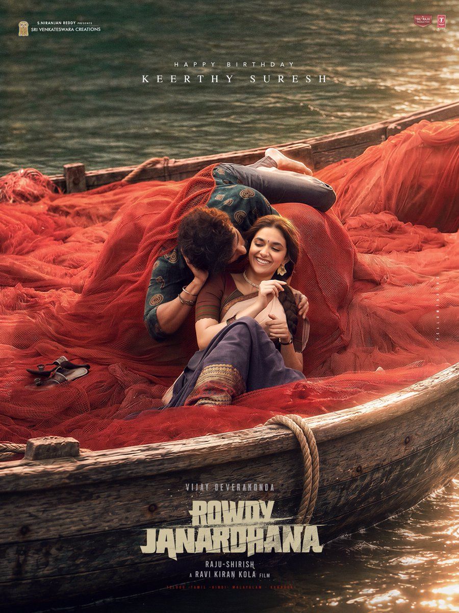 Rowdy Janardhana poster with Vijay Deverakonda and Keerthy Suresh lying in a wooden boat heaped with red fishing nets on a river