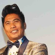 Peter Hein smiling in a gold jacket and bow tie