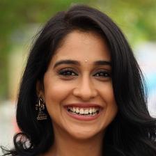 Regina Cassandra smiling with long dark hair, close-up portrait