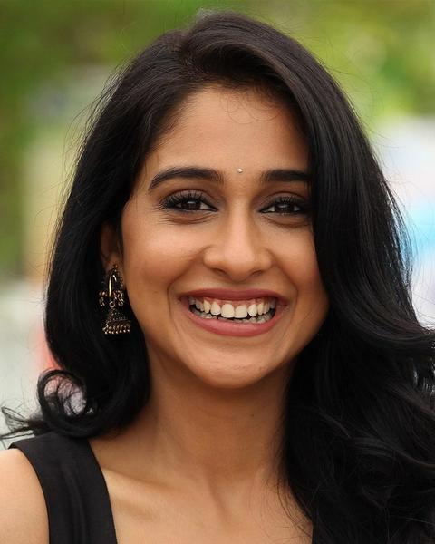 Regina Cassandra smiling with long dark hair, close-up portrait