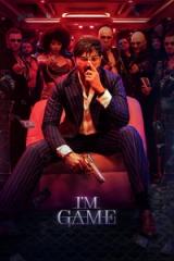 I'm Game poster with Dulquer Salmaan in a pinstripe suit, holding a gun, seated before a gang in a red-lit casino