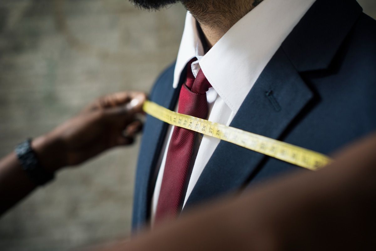 Tailor measuring a suit jacket