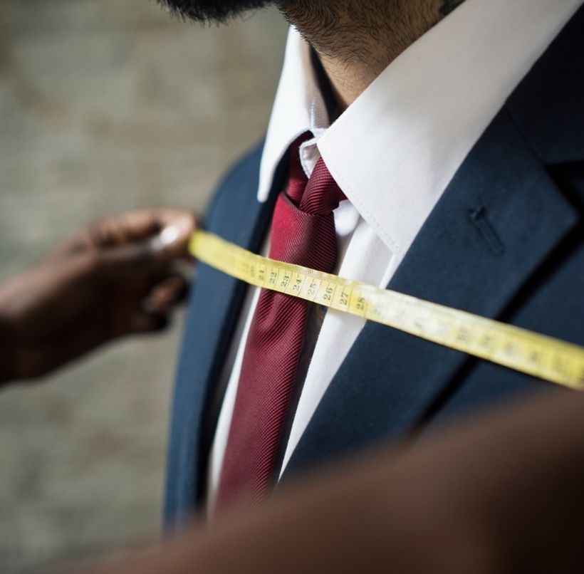 Tailor measuring a suit jacket