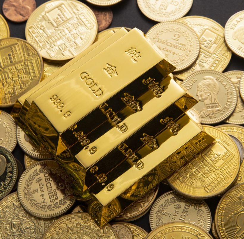 Gold bars on a pile of gold coins