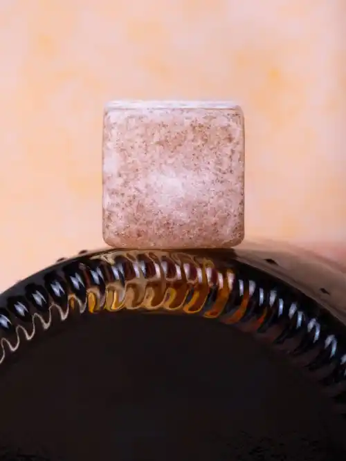 Ground Cherry Cola Rose Delights sits on top of a Mexican coke bottle.